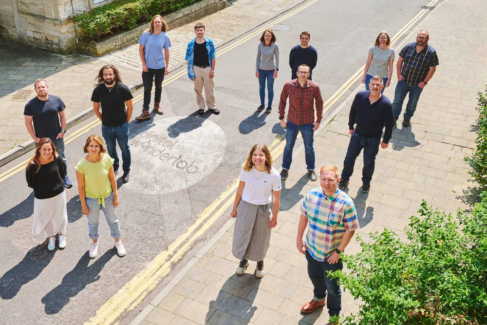 Digital Wonderlab team standing on the road looking up at the camera